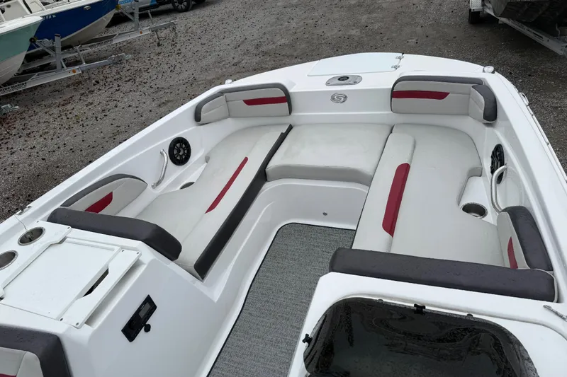 Slide: The Image of 2022 Hurricane SunDeck Sport 205 OB boat interior with cushioned seating and cup holders. - 18