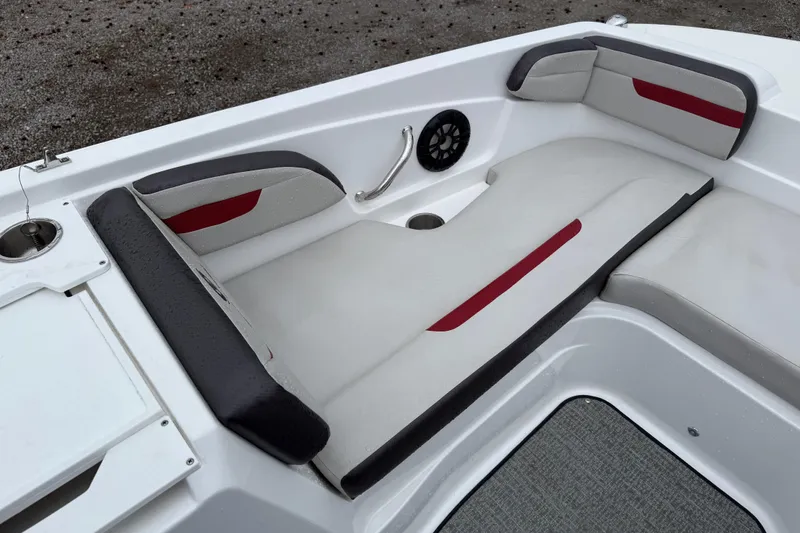 Slide: The Image of 2022 Hurricane SunDeck Sport 205 OB boat interior with cushioned seating and speaker. - 23