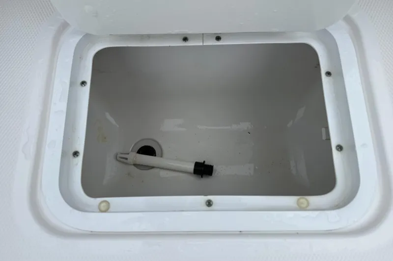 Slide: The Image of Open storage compartment on a 2022 Hurricane SunDeck Sport 205 OB boat. - 24