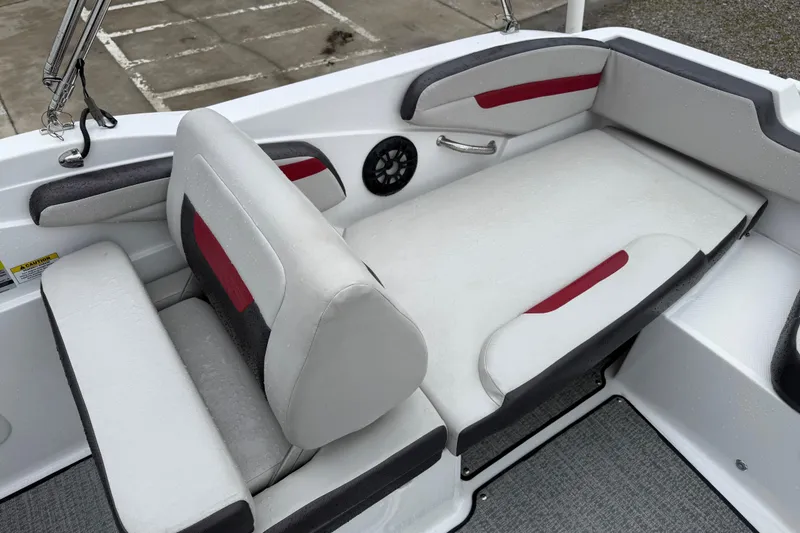Slide: The Image of 2022 Hurricane SunDeck Sport 205 OB boat interior with cushioned seating and speaker. - 28