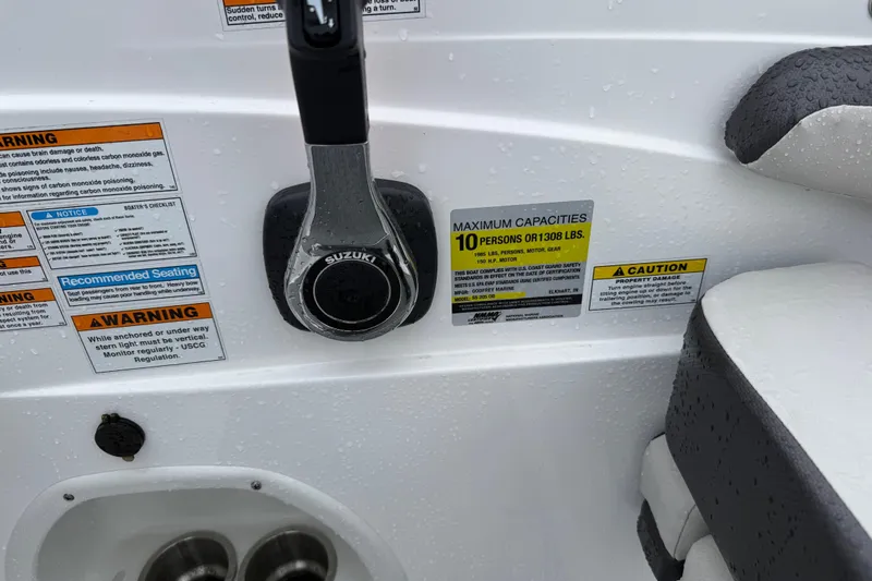 Slide: The Image of Close-up of 2022 Hurricane SunDeck Sport 205 OB boat controls and capacity warnings. - 29