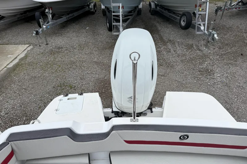 Slide: The Image of 2022 Hurricane SunDeck Sport 205 OB boat with outboard motor, parked on gravel. - 32