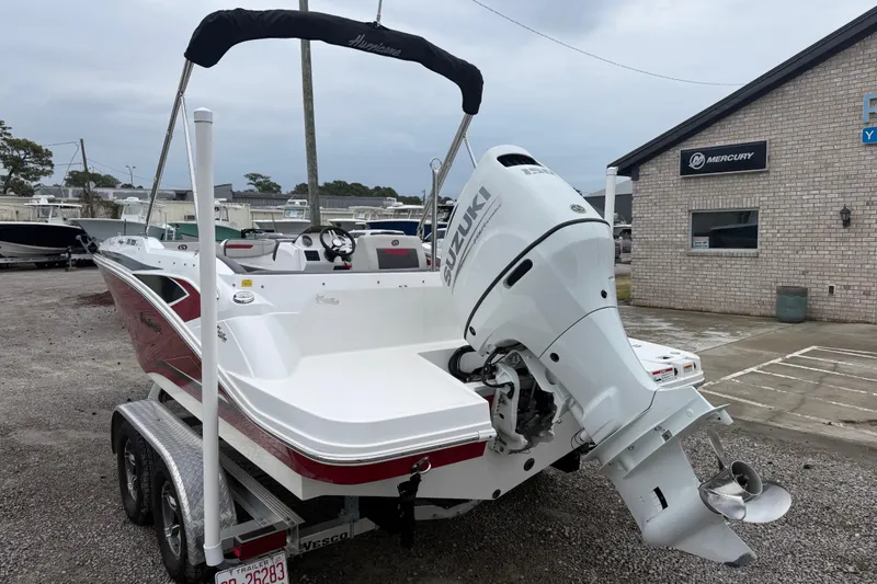 Slide: The Image of 2022 Hurricane SunDeck Sport 205 OB boat with Suzuki outboard motor on trailer. - 4