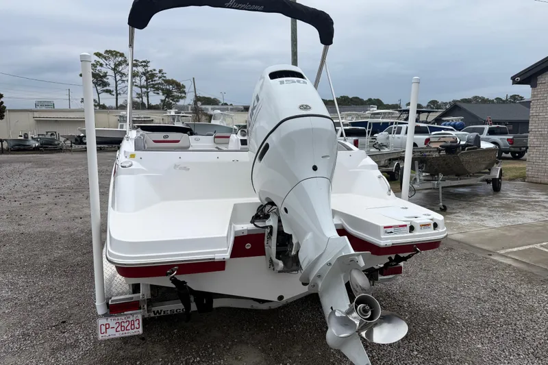 Slide: The Image of 2022 Hurricane SunDeck Sport 205 OB boat with outboard motor in a marina. - 5