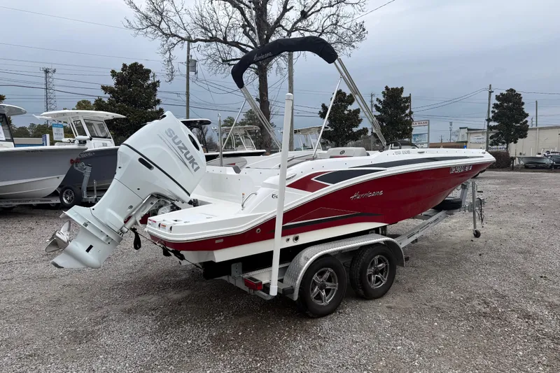 Slide: The Image of 2022 Hurricane SunDeck Sport 205 OB boat with Suzuki outboard motor on trailer. - 9