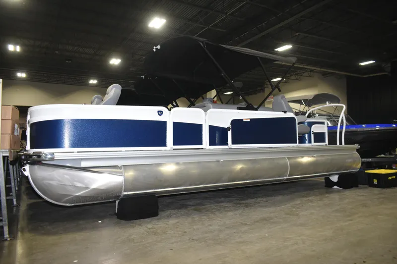 Slide: The Image of 2026 Premier 230 Sunsation Angler 4PT PTX pontoon boat displayed indoors. - 3