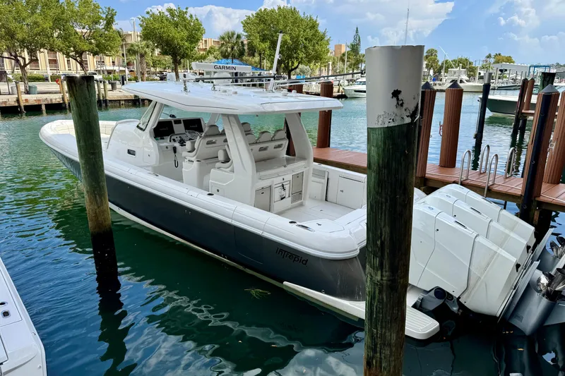 The Image of 2024 Intrepid 427 Nomad SE boat docked in a marina, featuring sleek design and powerful engines. - 0