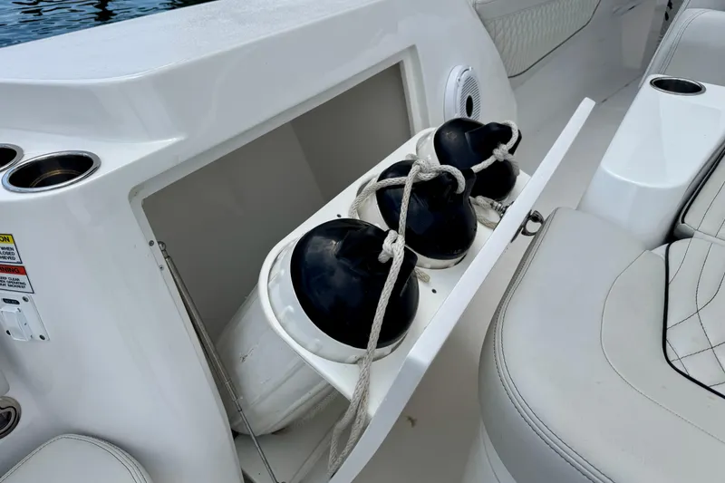 Slide: The Image of Storage compartment with fenders on a 2024 Intrepid 427 Nomad SE boat. - 13