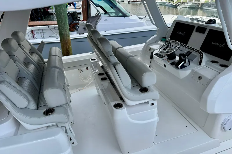 Slide: The Image of 2024 Intrepid 427 Nomad SE boat interior with luxurious seating and advanced navigation system. - 15