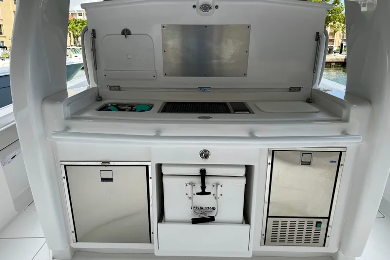 Slide: The Image of 2024 Intrepid 427 Nomad SE boat galley with storage compartments and appliances. - 17