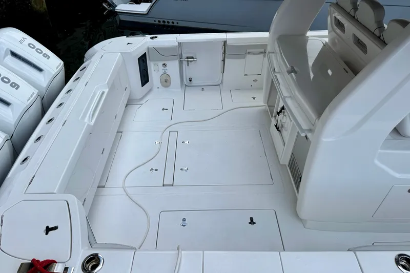 Slide: The Image of 2024 Intrepid 427 Nomad SE boat deck with seating and storage compartments. - 19