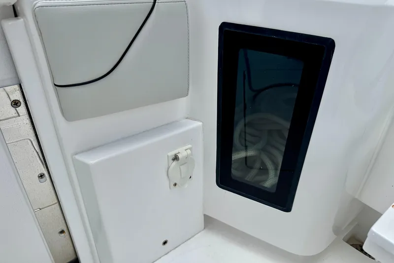 Slide: The Image of 2024 Intrepid 427 Nomad SE boat interior detail with storage compartment and window. - 20