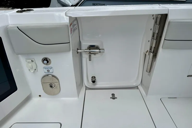 Slide: The Image of 2024 Intrepid 427 Nomad SE boat interior, featuring a sleek white design and modern fittings. - 22