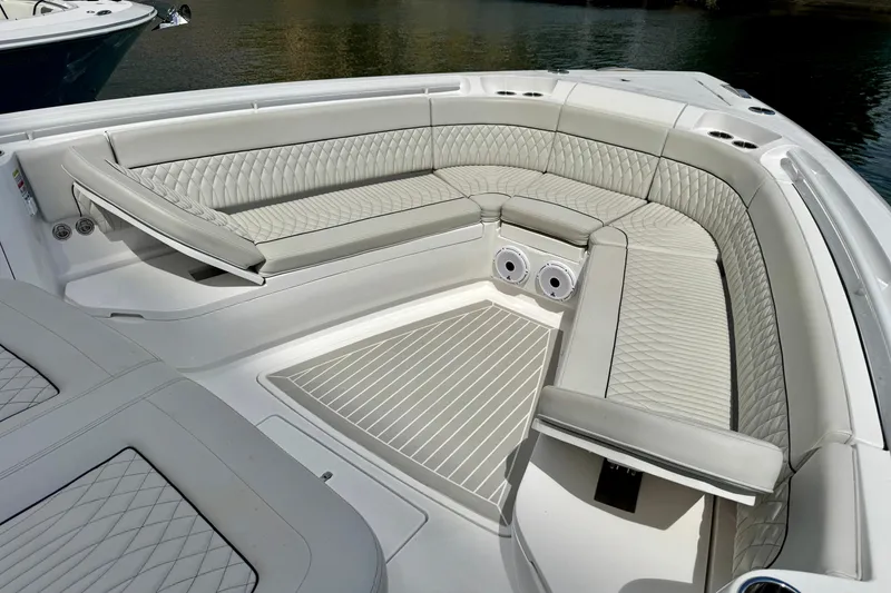 Slide: The Image of Luxurious seating area on 2024 Intrepid 427 Nomad SE boat, featuring elegant quilted upholstery. - 23