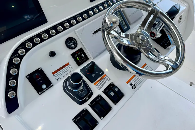 Slide: The Image of 2024 Intrepid 427 Nomad SE boat dashboard with steering wheel and controls. - 6