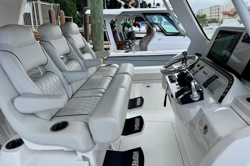 Slide: The Image of Luxurious interior of 2024 Intrepid 427 Nomad SE boat with plush seating and advanced controls. - 7