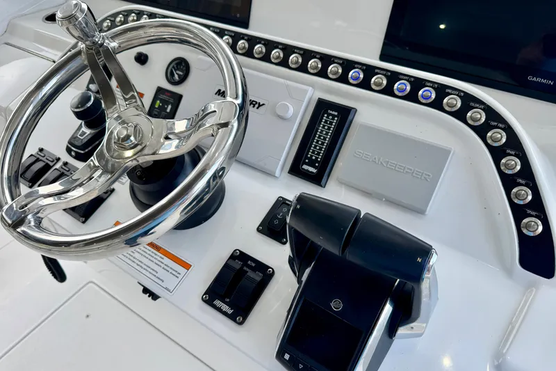 Slide: The Image of 2024 Intrepid 427 Nomad SE helm with steering wheel and control panel. - 8