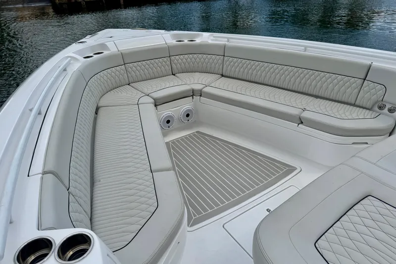 Slide: The Image of Luxurious seating area on the 2024 Intrepid 427 Nomad SE boat, featuring elegant quilted upholstery. - 9