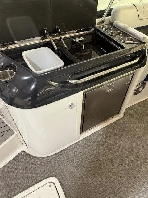Slide: The Image of 2016 Formula 350 FX Crossover Bowrider kitchenette with sink and fridge. - 28