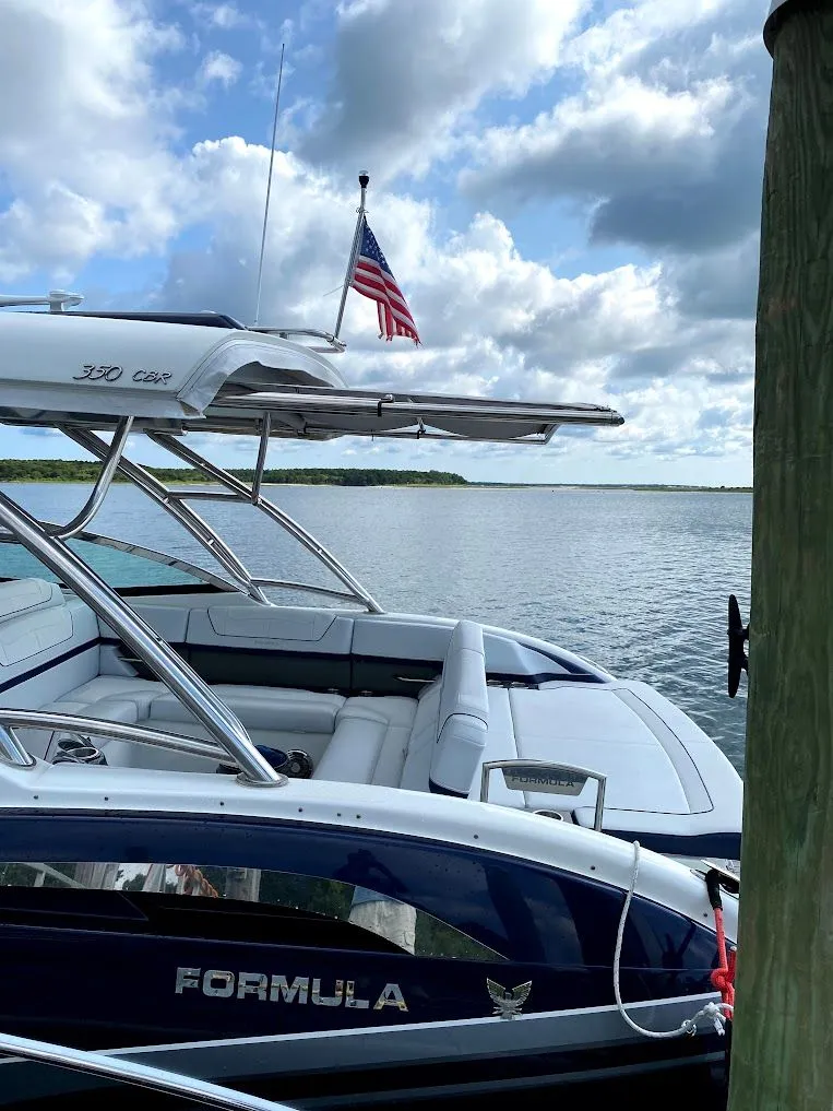 Slide: The Image of 2016 Formula 350 FX Crossover Bowrider on calm water with flag. - 4