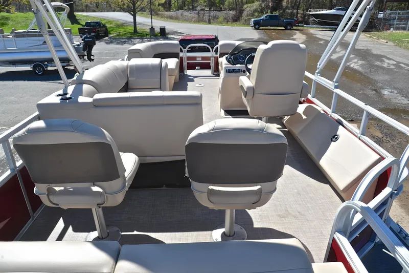 Slide: The Image of 2019 Sun Tracker SportFish 22 DLX pontoon boat interior with beige seating and steering console. - 18