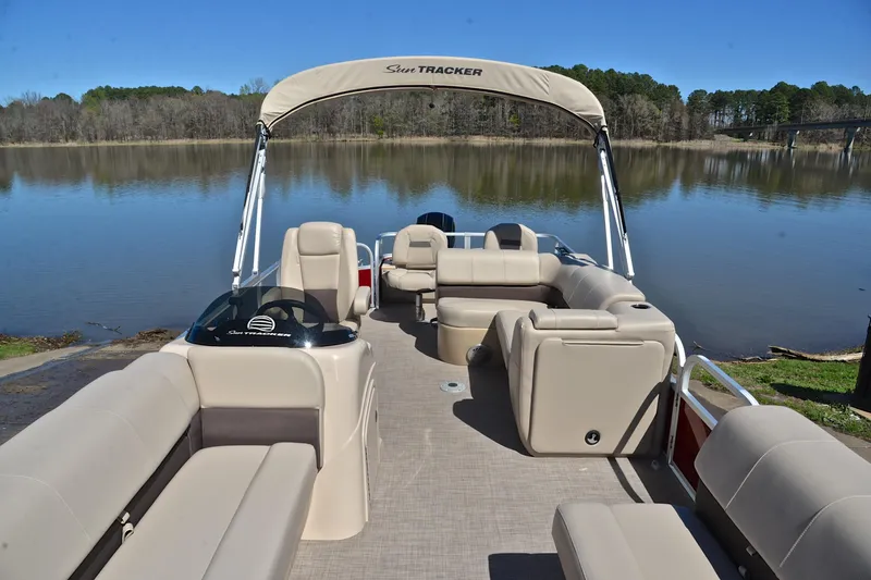 Slide: The Image of 2019 Sun Tracker SportFish 22 DLX pontoon boat on a serene lake. - 20