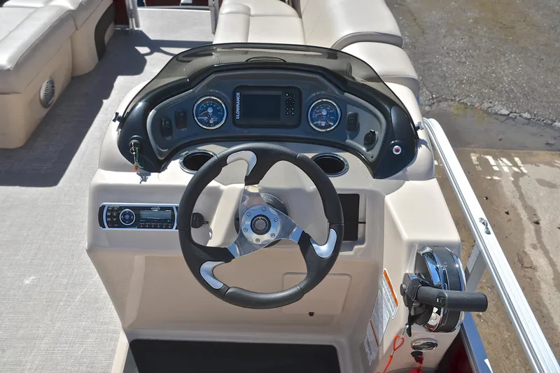 Slide: The Image of 2019 Sun Tracker SportFish 22 DLX boat dashboard with steering wheel and control panel. - 26