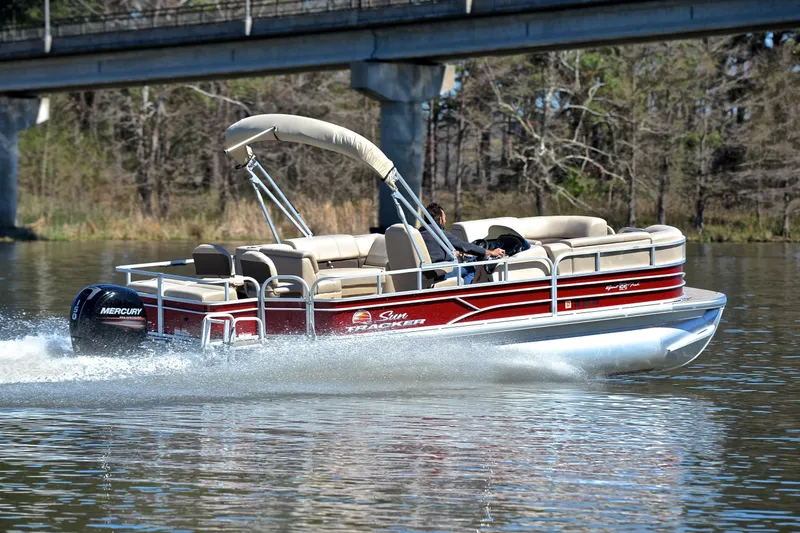 Slide: The Image of 2019 Sun Tracker SportFish 22 DLX pontoon boat cruising on a lake. - 5
