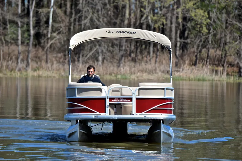 Slide: The Image of 2019 Sun Tracker SportFish 22 DLX pontoon boat on a calm lake. - 9