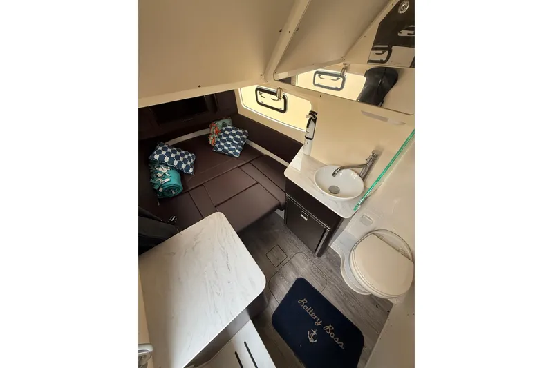 Slide: The Image of 2021 Scout 355 LXF cabin interior with bed, sink, and toilet. - 14