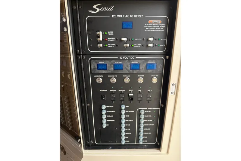 Slide: The Image of Electrical control panel of 2021 Scout 355 LXF boat, featuring 120V AC and 12V DC systems. - 18