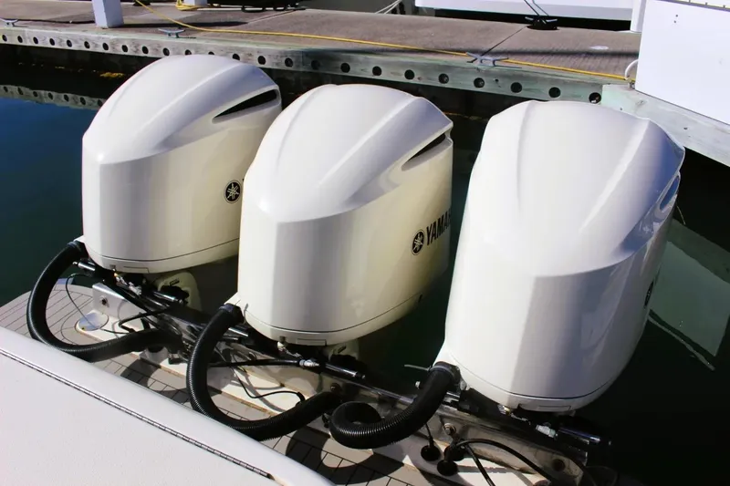 Slide: The Image of Triple Yamaha outboard engines on a 2021 Scout 355 LXF boat at the dock. - 4