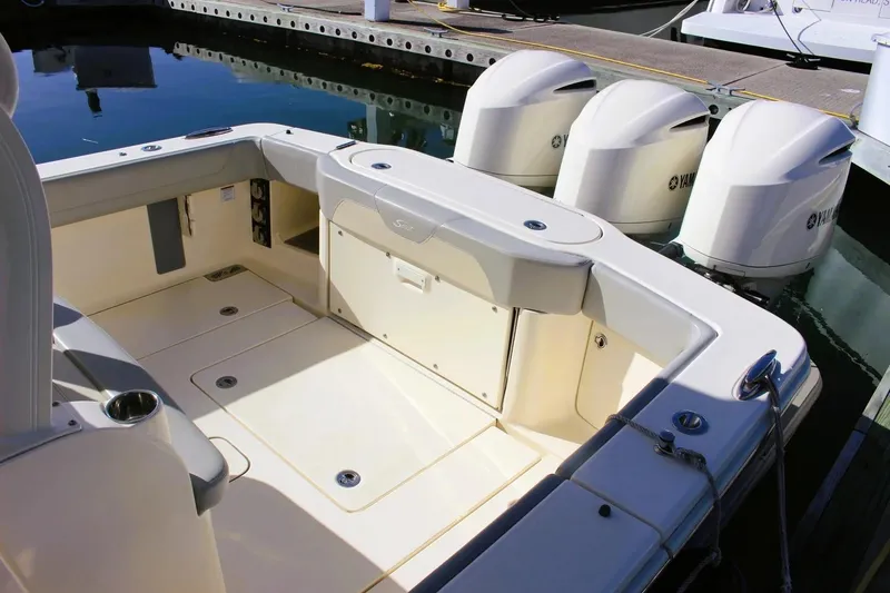 Slide: The Image of 2021 Scout 355 LXF boat with Yamaha engines docked at marina. - 8