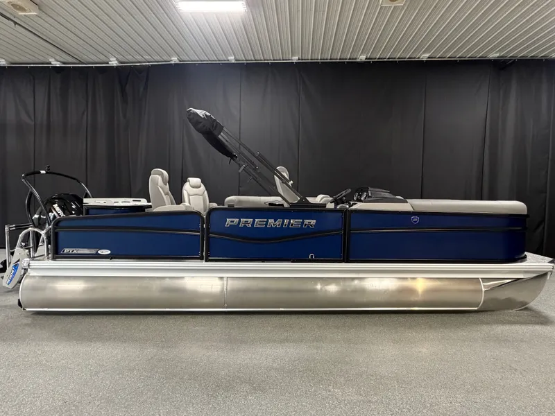 Slide: The Image of A modern pontoon boat with blue side panels and a silver hull, featuring comfortable seating. - 1