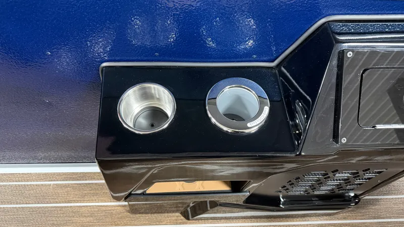 Slide: The Image of Cup holders and dashboard on a boat with blue wall and wooden flooring. - 30