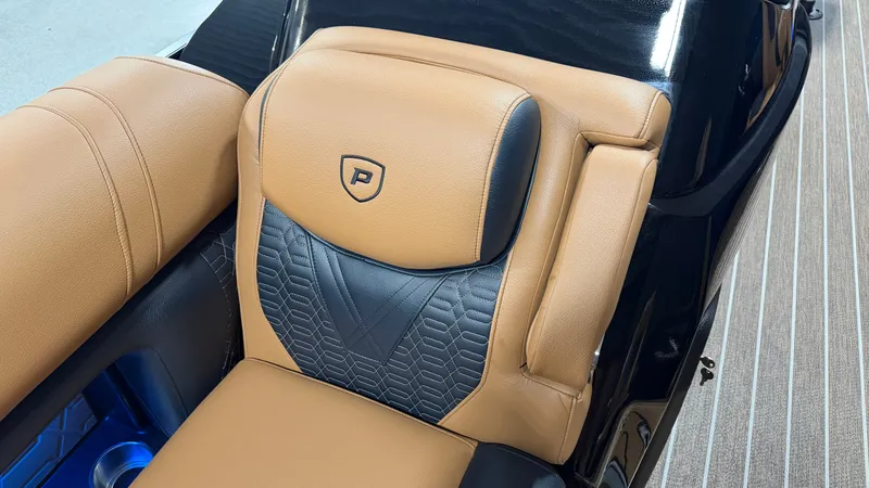 Slide: The Image of Luxurious seating area with brown and black leather, quilted pattern, and Premier logo. - 21