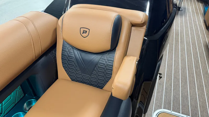 Slide: The Image of Luxurious seat with brown and black upholstery, quilted pattern, and armrest on a boat. - 22