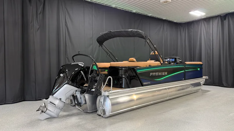 Slide: The Image of The image shows a 2027 Premier 250INTRIGUE pontoon boat with an outboard motor in a showroom. - 2