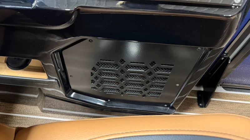 Slide: The Image of Close-up of a black vent grille in a boat with brown upholstery. - 39