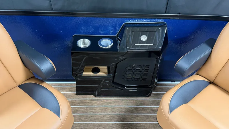 Slide: The Image of Two brown seats with blue armrests, separated by a black console with cup holders. - 26