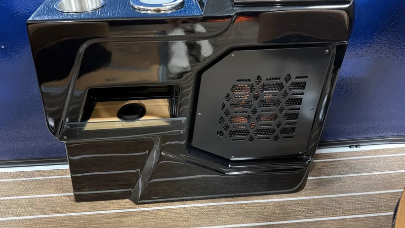 Slide: The Image of Close-up of a glossy black boat panel with a vented grille and cup holder. - 27