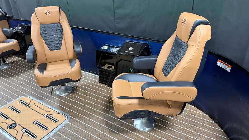 Slide: The Image of Two luxurious, swiveling captain's chairs in a modern boat with wood flooring and blue accents. - 23