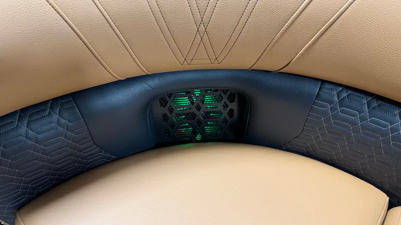 Slide: The Image of Close-up of a luxurious seat with blue and beige upholstery and green lighting. - 11