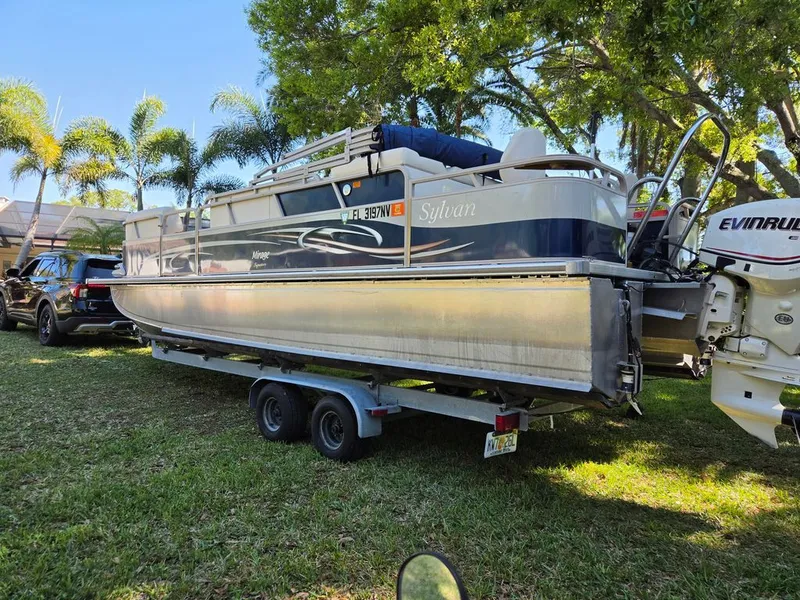 The Image of 2008 Sylvan 8520 Mirage Cruise on trailer under palm trees. - 0