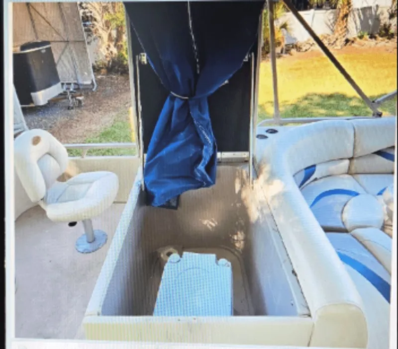 Slide: The Image of Interior of a 2008 Sylvan 8520 Mirage Cruise boat with seating area. - 2