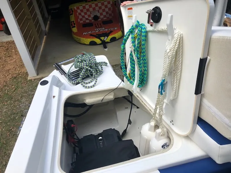 Slide: The Image of 2024 Tahoe 185 S storage compartment with ropes and accessories. - 16