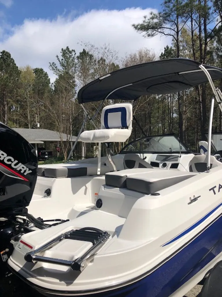 Slide: The Image of 2024 Tahoe 185 S boat with Mercury engine, parked outdoors. - 2