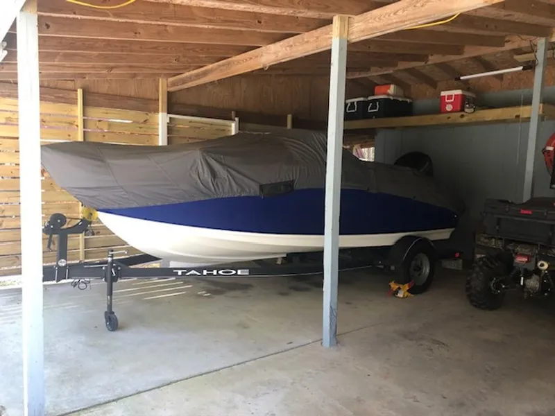 Slide: The Image of 2024 Tahoe 185 S boat covered in garage. - 25