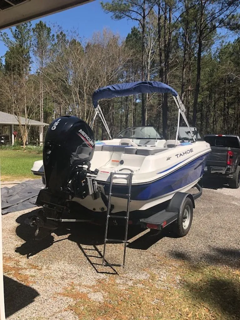 Slide: The Image of 2024 Tahoe 185 S boat on trailer parked outdoors. - 26