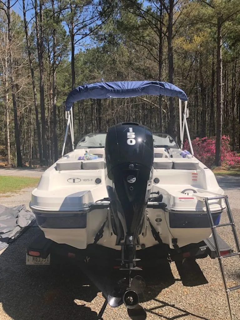 Slide: The Image of 2024 Tahoe 185 S boat with outboard motor in forest setting. - 27